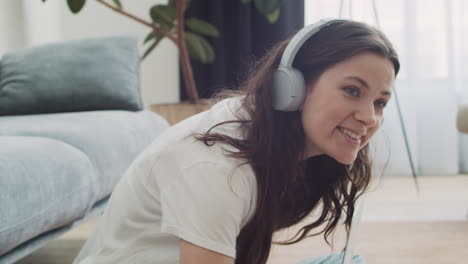 Young-Woman-Calls-Her-Dog-To-Feed-Him-While-Working-On-Her-Laptop-At-Home-1