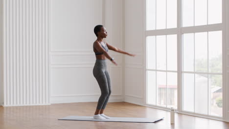 woman doing jumping jacks in a modern room