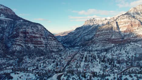 Establishing-drone-aerial-of-Ouray,-Colorado-in-the-winter-on-a-sunny-day