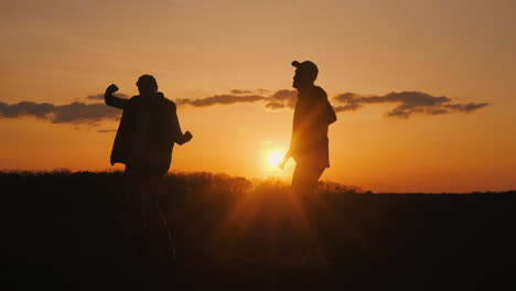 friends dancing at sunset