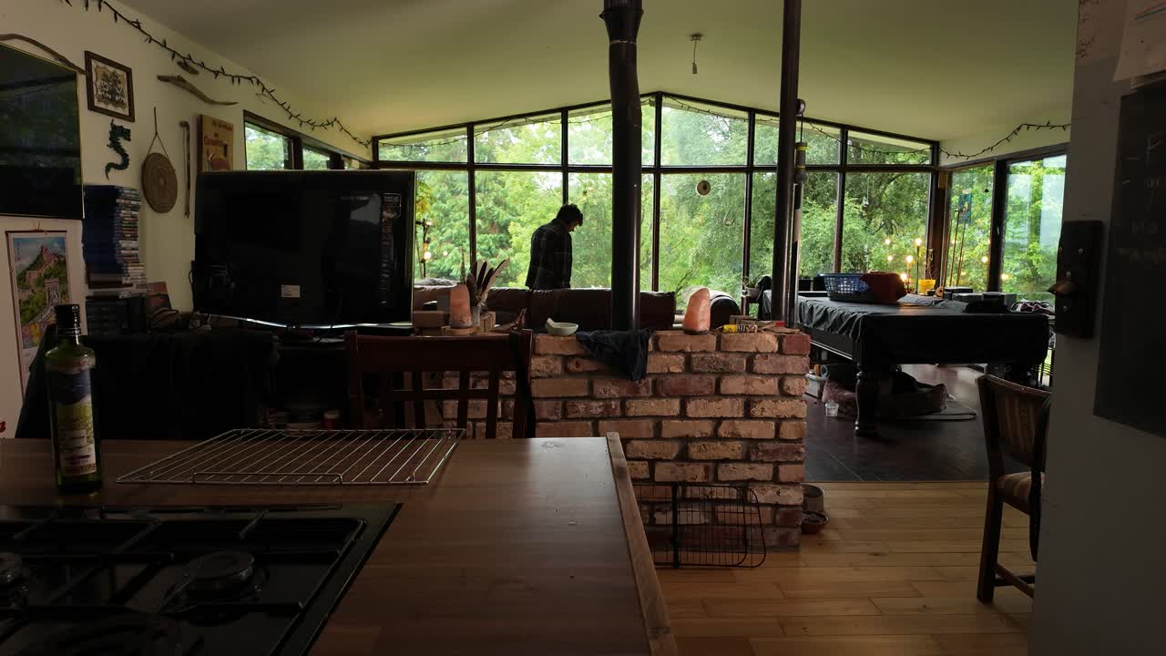 Interior view of modern wooden cabin home with person cleaning