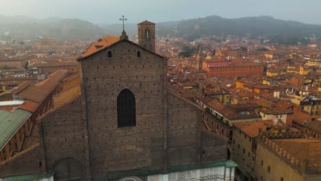 drone flies above basilica san petronio in piazza maggiore, bologna, italy