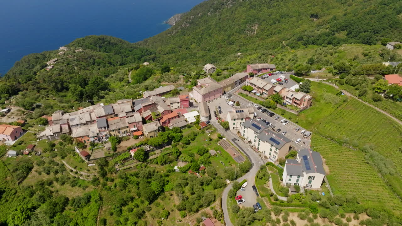 Panoramic drone shot circling the Montaretto town, summer day in Liguria, Italy