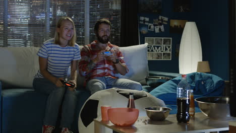 couple playing video games at home