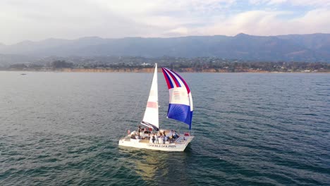 aerial over a catamaran sailboat sailing off the coast of santa barbara california 1