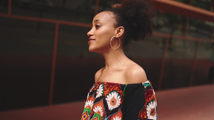 Portrait of a woman with afro hair and ethnic print top