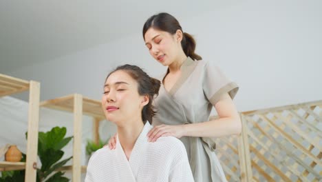 woman receiving a shoulder massage at a spa