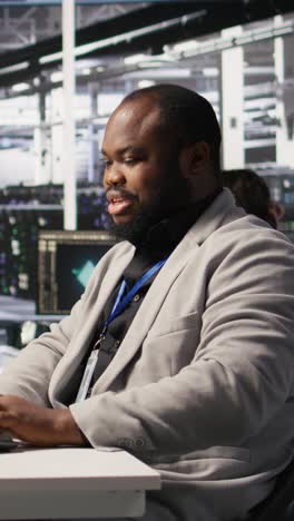 vertical video data center system administrator monitoring servers gear performing ai training