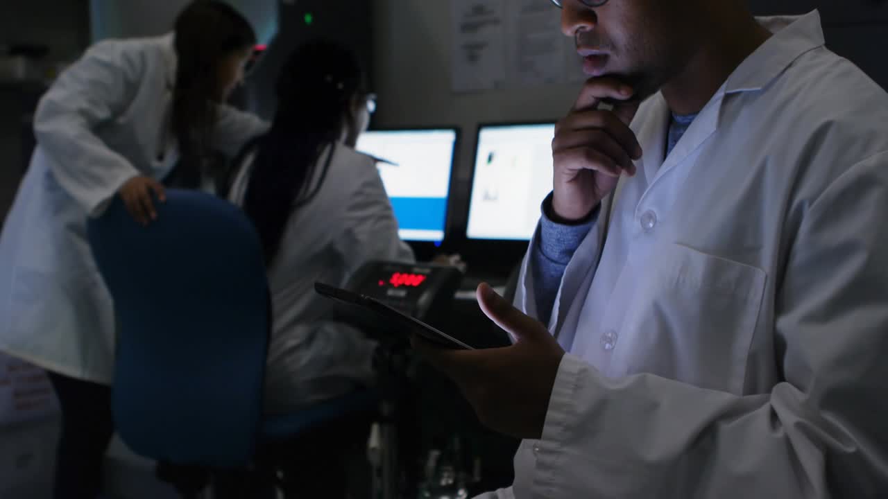 Researcher tapping tablet causing animated social icons rising on lab screens for metrics tracking