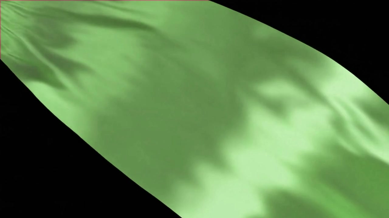 Flowing Green Silk Fabric Against Black Background