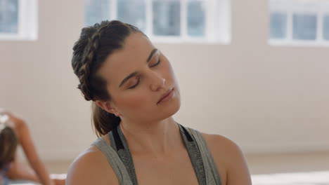 yoga class beautiful caucasian woman stretching neck practicing meditation enjoying healthy lifestyle exercising with group of people in fitness studio