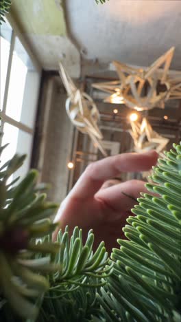 hand reaching for a christmas tree ornament