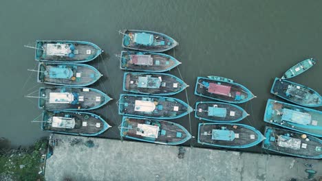 ascending top down shot of docking old fishing boats in india