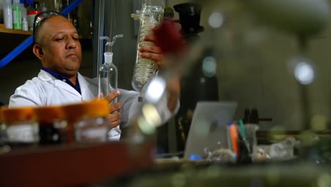 Front-view-of-mature-male-worker-checking-glass-product-in-glass-factory-4k