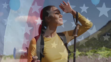 animación de la bandera estadounidense sobre una mujer biracial mirando hacia las montañas