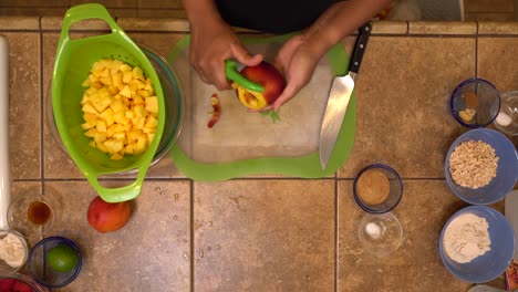 peeling and dicing peaches for a homemade recipe - overhead isolated view