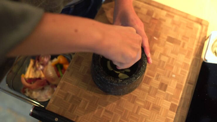 Close Up of Female Hands Grinding Onion