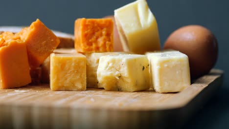 cheese cubes green, yellow and red  on chopping board