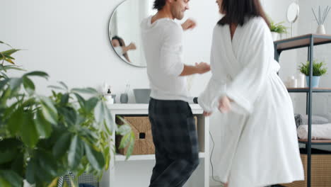 happy couple dancing in the bathroom