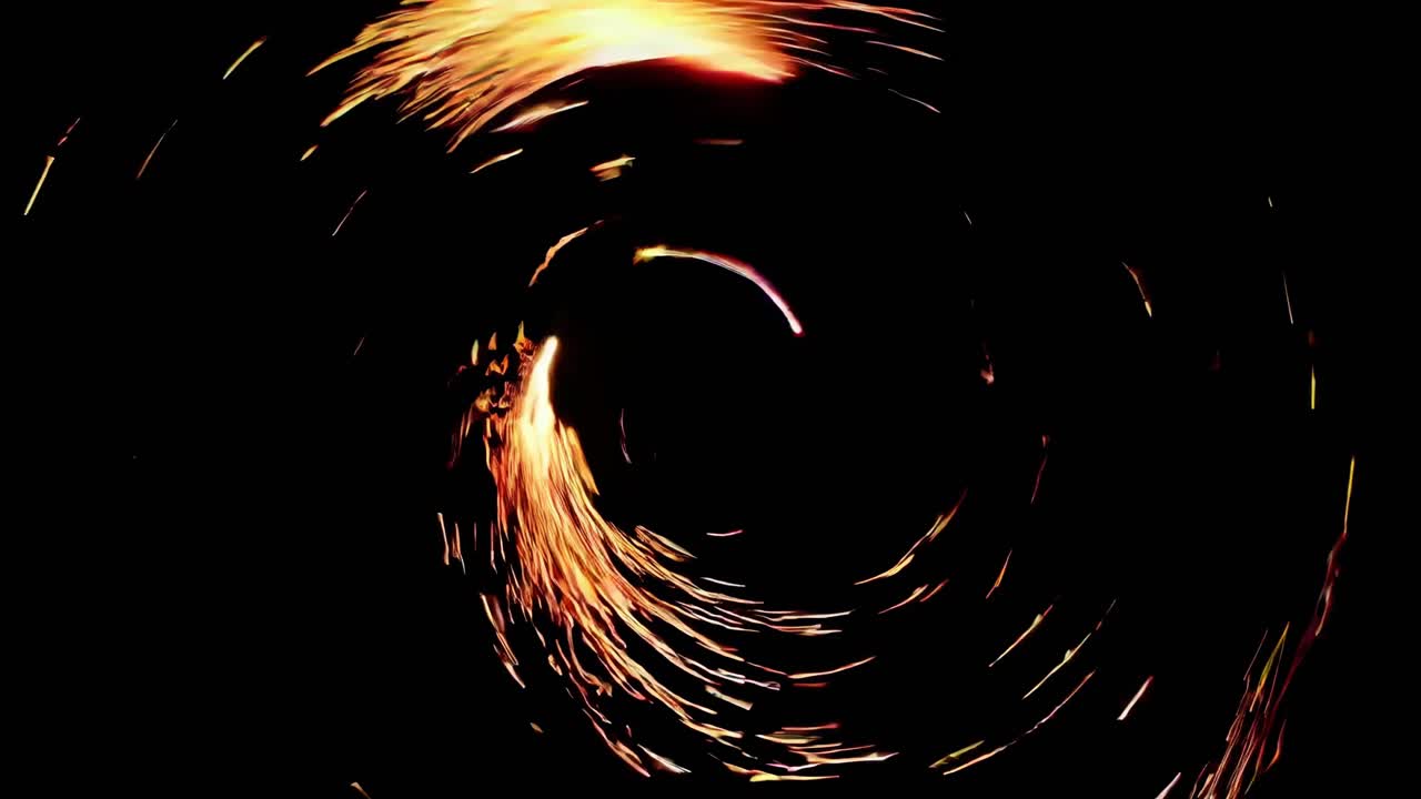 Two fire circles are intersecting creating a mesmerizing pattern of sparks and flames, illuminating the night with a fiery spectacle of light and motion
