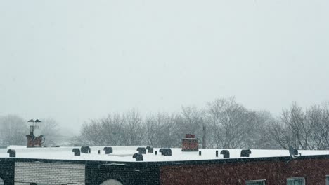 urban building roof with chimneys and satellite dish covered in snow 4k