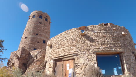 Reveal-panning-shot-of-the-Mary-Colter's-Desert-View-Watchtower-at-the-Grand-Canyon-South-Rim,-Arizona,-United-States