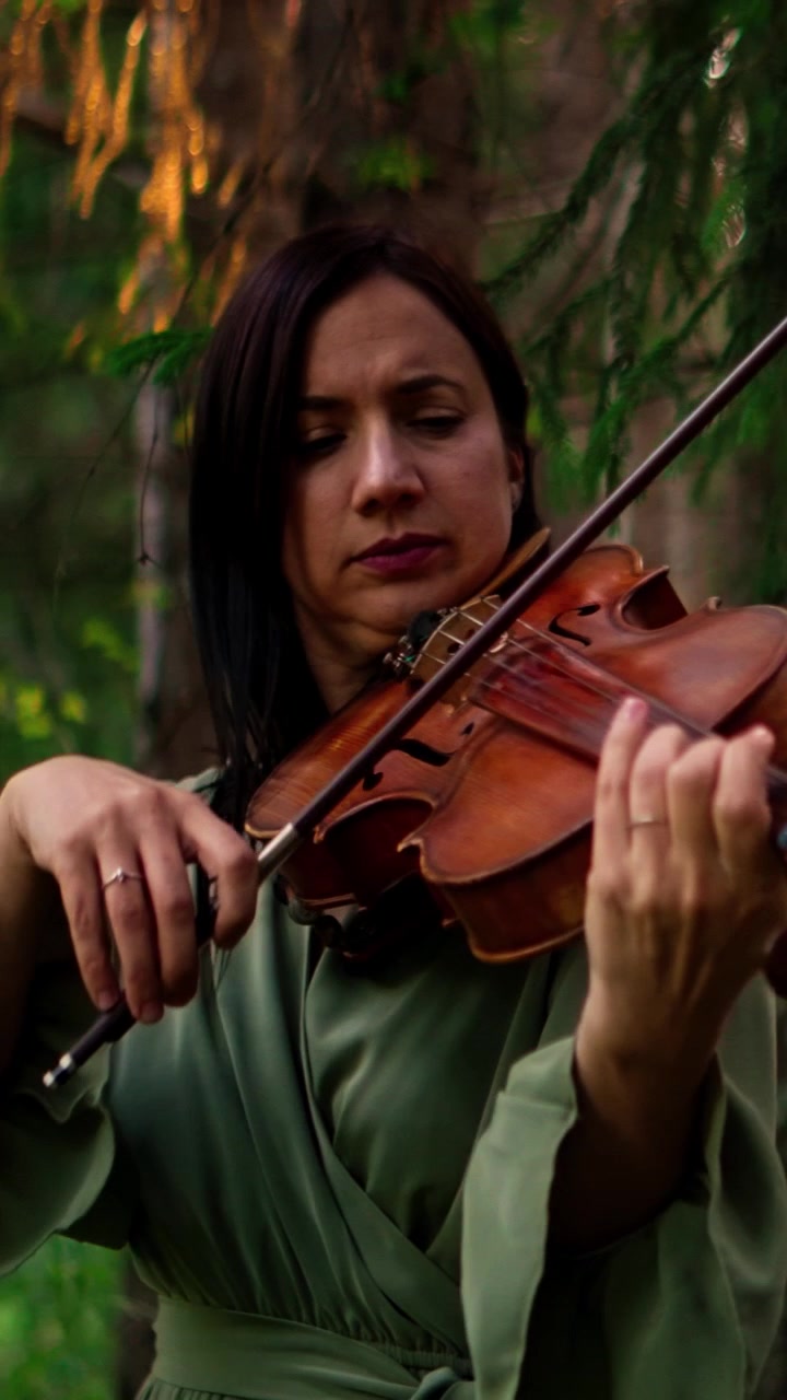 Woman Playing Violin in a Forest Setting