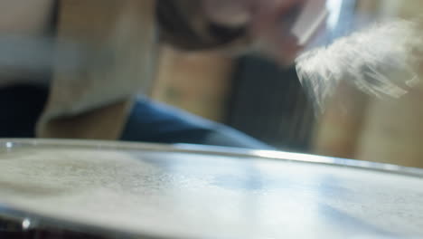 close up view of playing drum with wire brushes