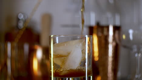 soda poured in to rocks glass with ice in slow motion