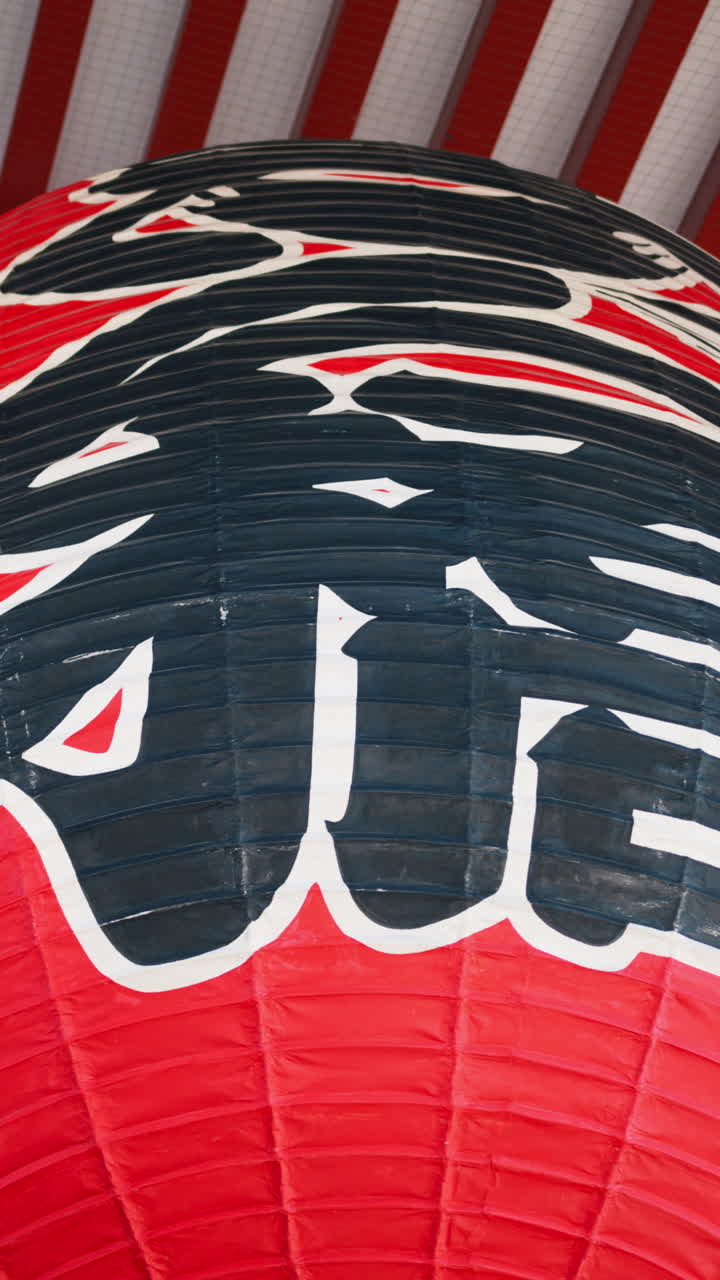Close up of hanging paper lanterns at the Senso-ji temple in Asakusa, Tokyo, Japan. Vertical. Translation: "Kobuna Town"