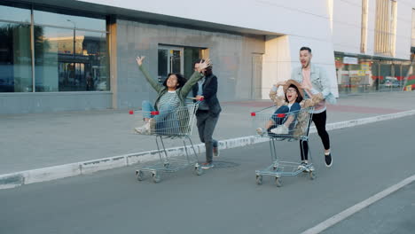 Friends Having Fun with Shopping Cart Race