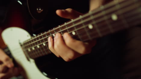 musician playing electric guitar in studio