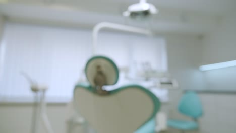 blurred modern dental practice. dental chair and other accessories used by dentists in blue, medic light