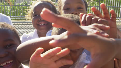 young school kids in playground wave to camera, slow motion