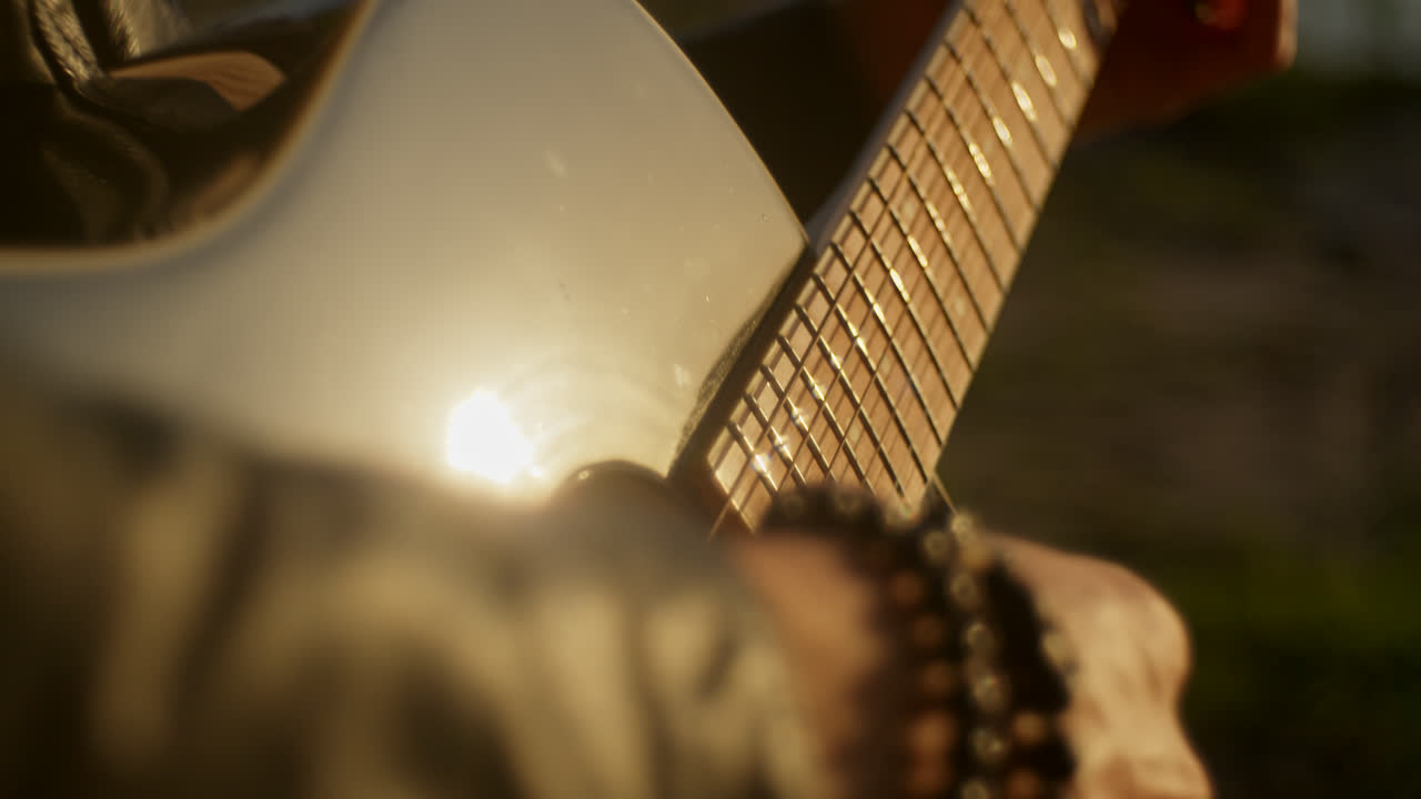 Playing Acoustic Guitar at Sunset