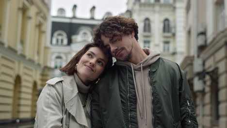 Happy-couple-cuddling-together-on-street.-Romantic-man-and-woman-having-date.