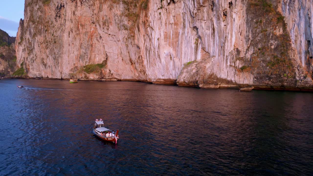 Aerial view of boats on sea near giant rocks of The Maya Bay in Kho Phi Phi