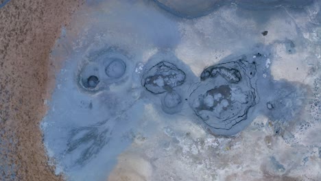 spectacular drone shot of geothermal mud pool in blue color named hverir,iceland