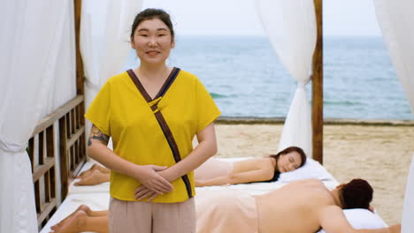 masseuse with clients in the beach