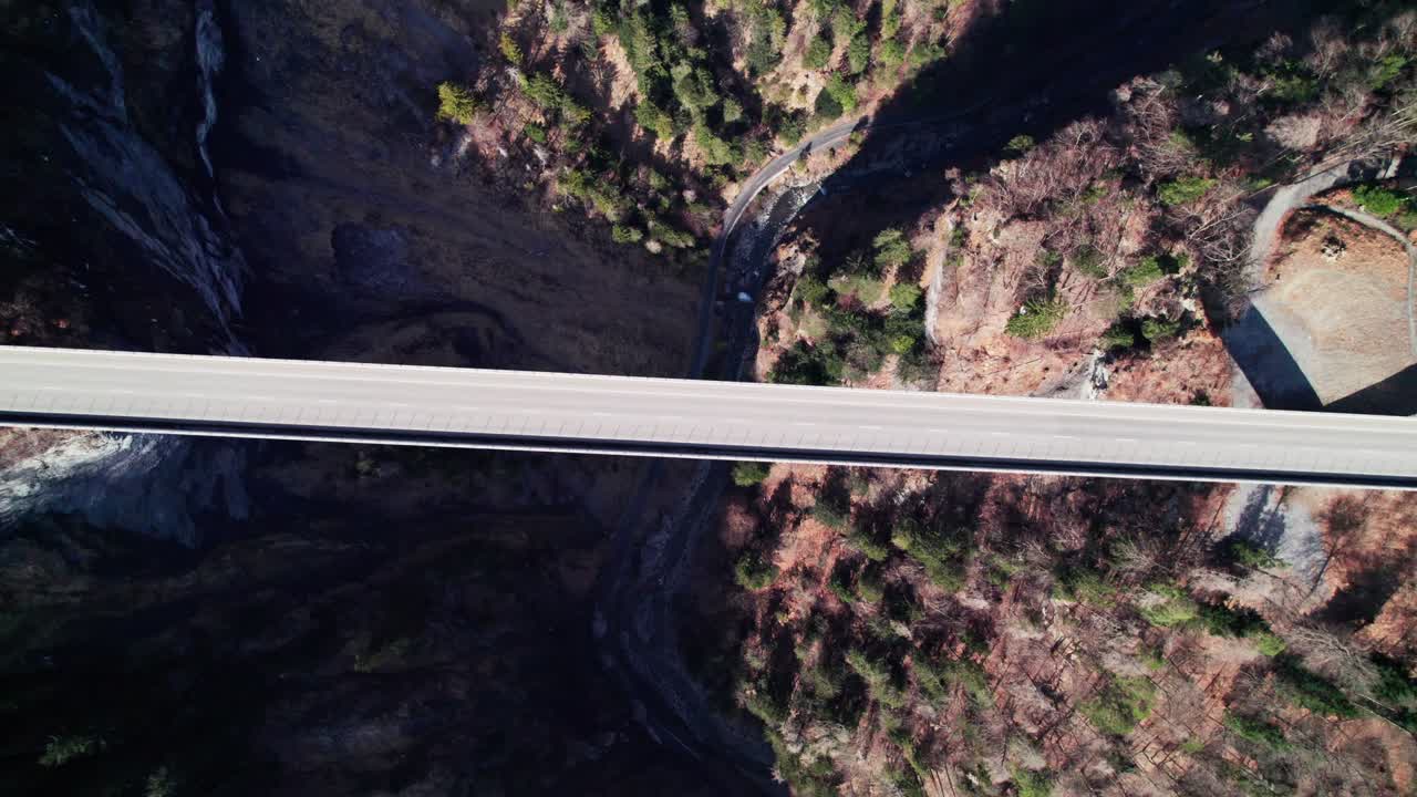 Aerial Birds Eye View Of Car Driving Across Tamina Bridge