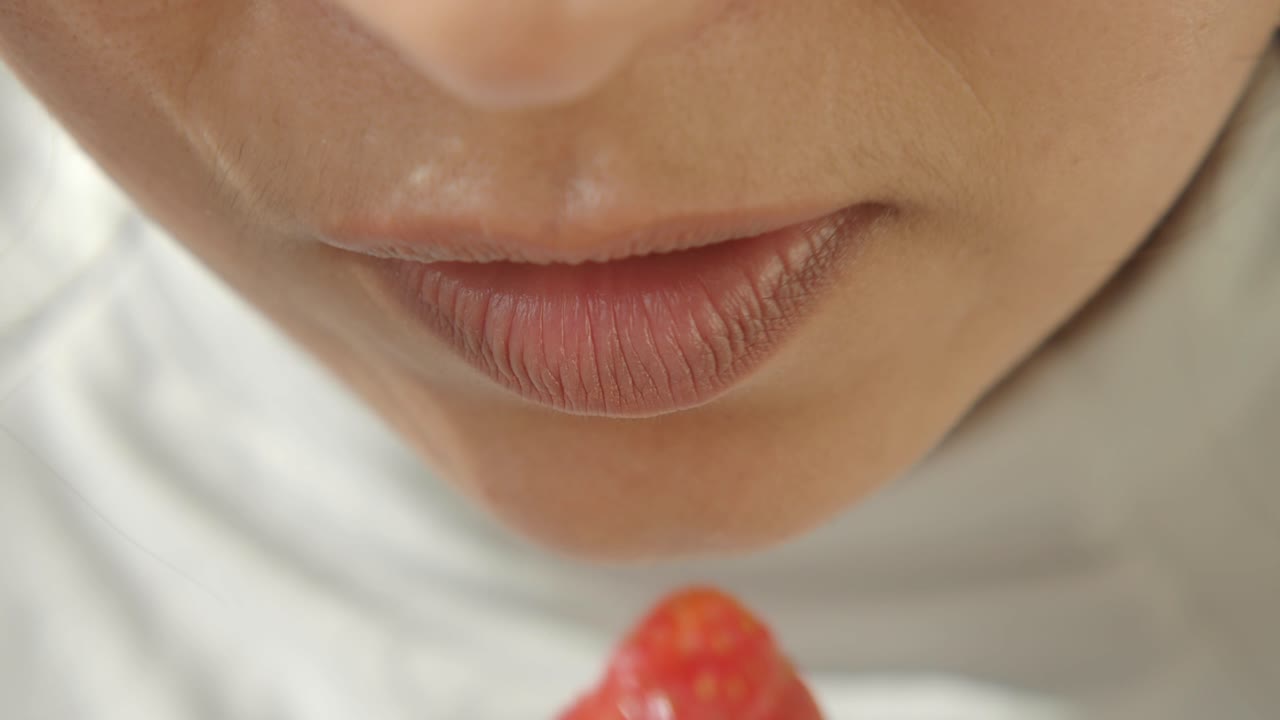 Woman Eating a Strawberry