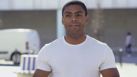 Handsome-young-guy-wearing-white-t-shirt-talking-to-camera.