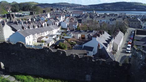 welsh holiday cottages enclosed in conwy castle stone battlements walls aerial view jib up left