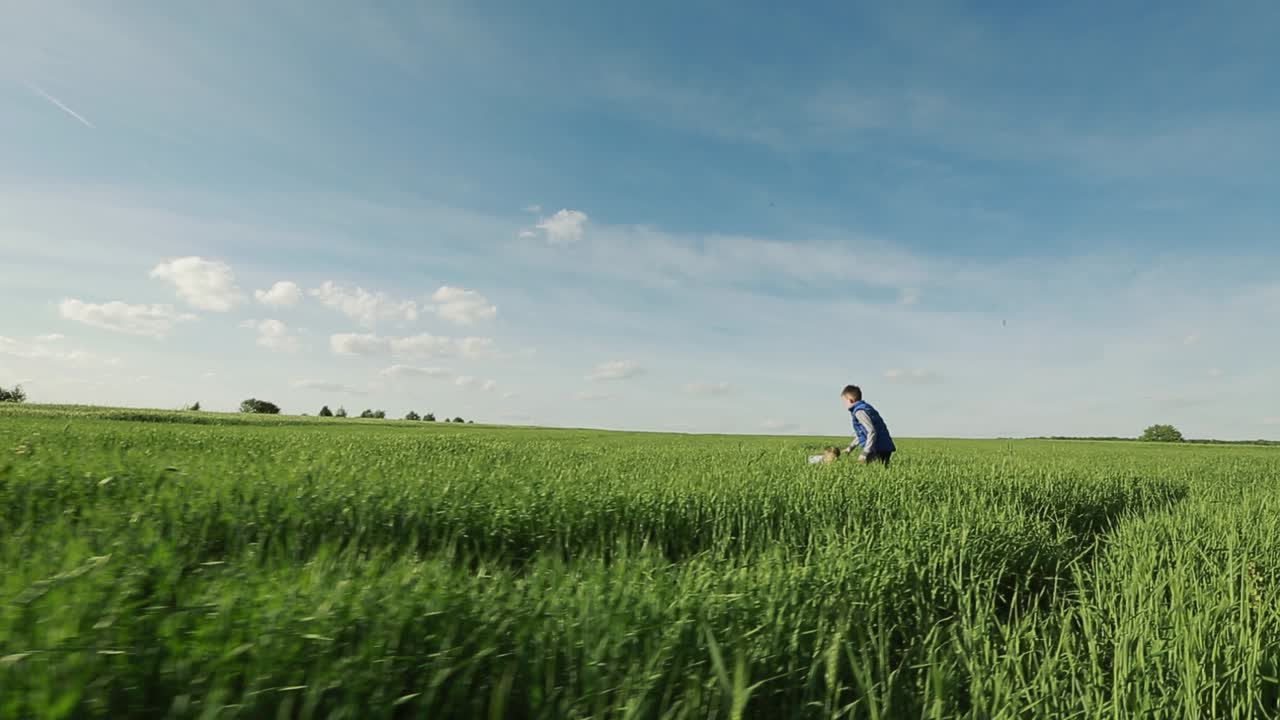 Joyful Kids Running On The Grass. Happy joyful kids running on the grass in the summer park