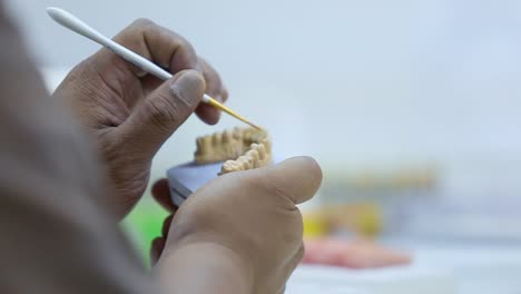 closeup shot for a technician preparing a denture