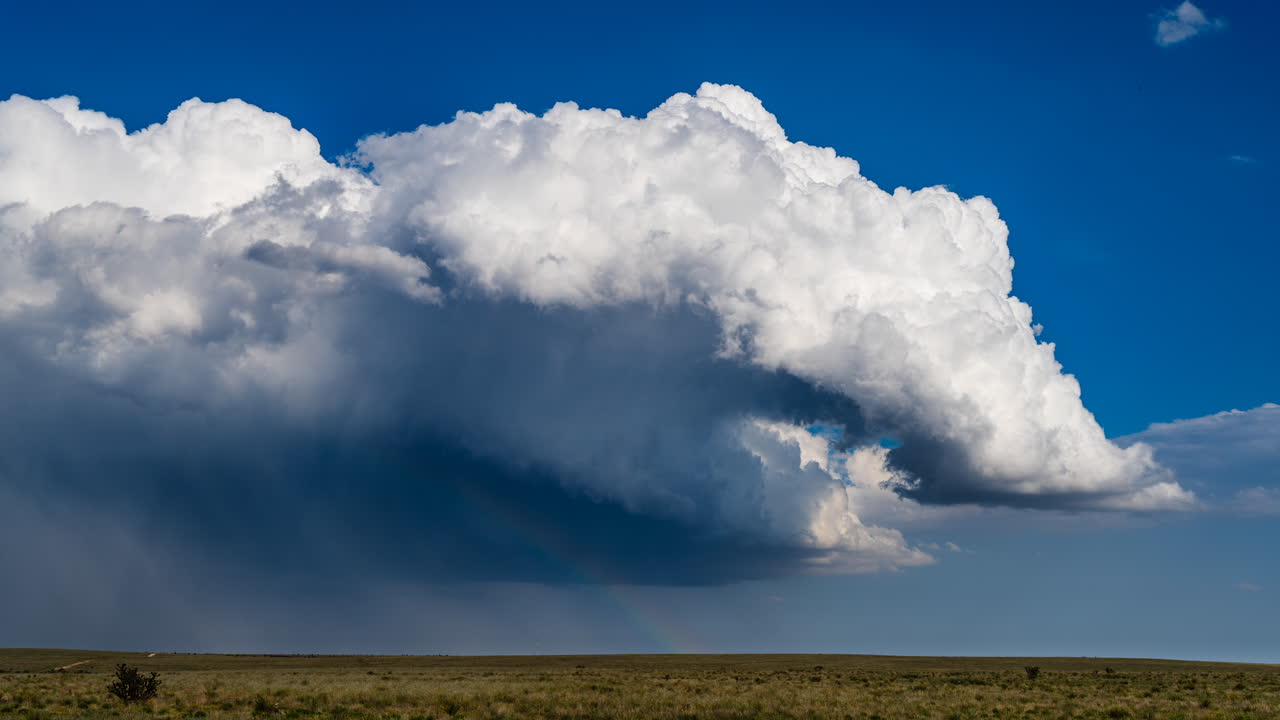 White clouds build and drift across beautiful blue sky