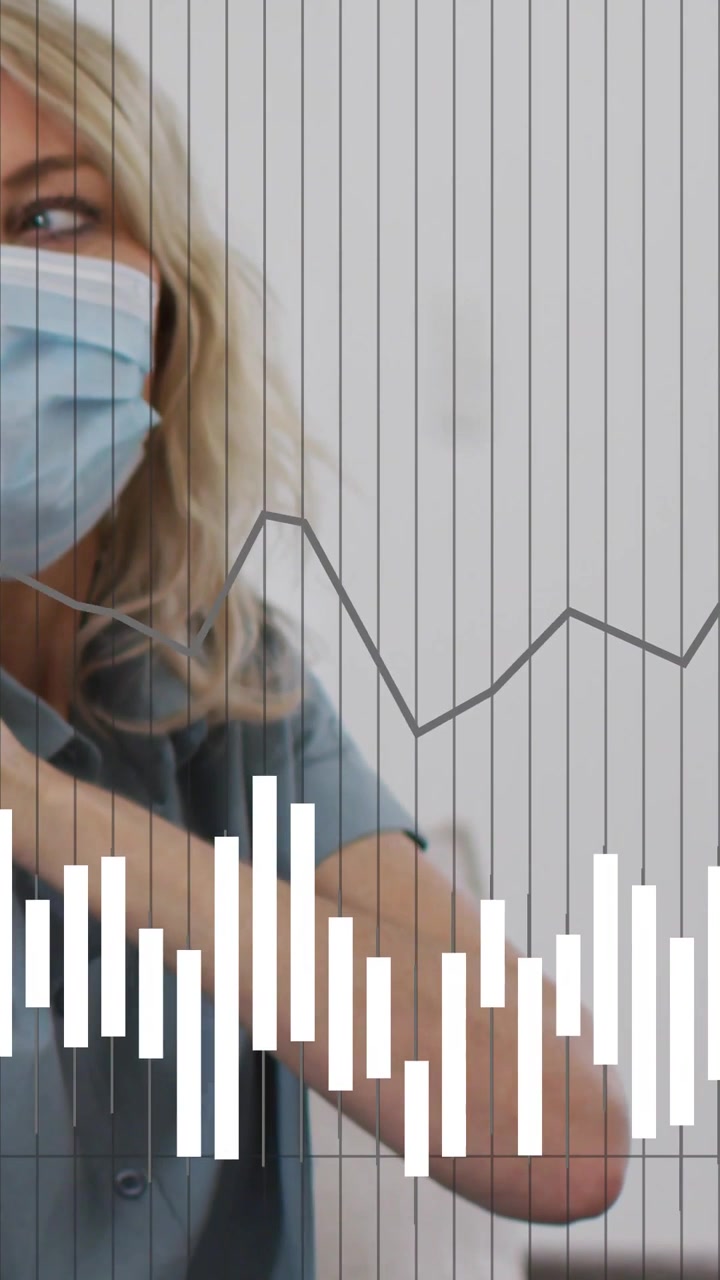 Vertical video: Masked clinician adjusting arm, glancing as pulsing overlays showing vitals chart