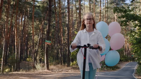 blonde girl rides electric scooter through park with balloons 1