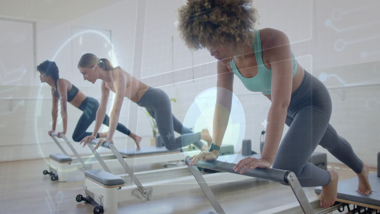 Women exercising on reformer machines with digital data overlay animation