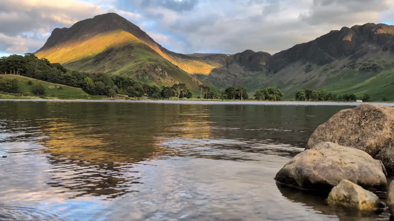 views of Buttermere Lake sunset. Fleetwith pike, The calm water reflects the iconic Lake District fells